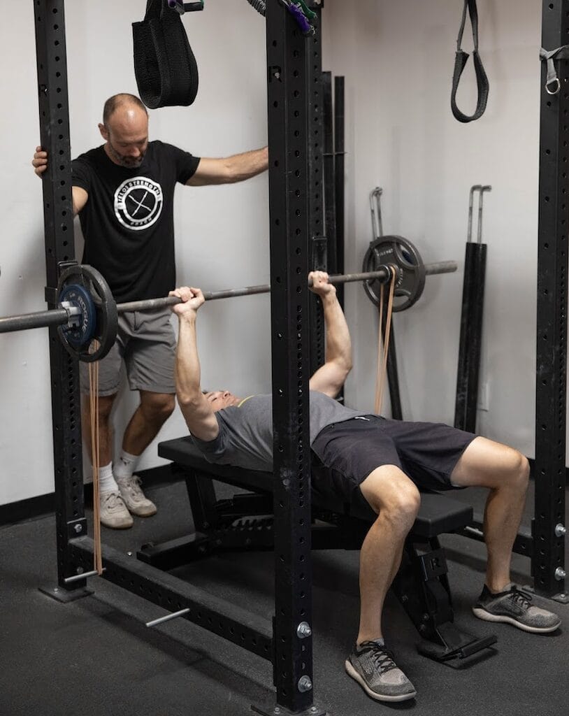 Busy professional training at Telos Strength in Tucson to boost energy naturally through strength training. 