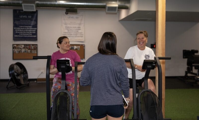 Personal training coach asking client about readiness before strength workout